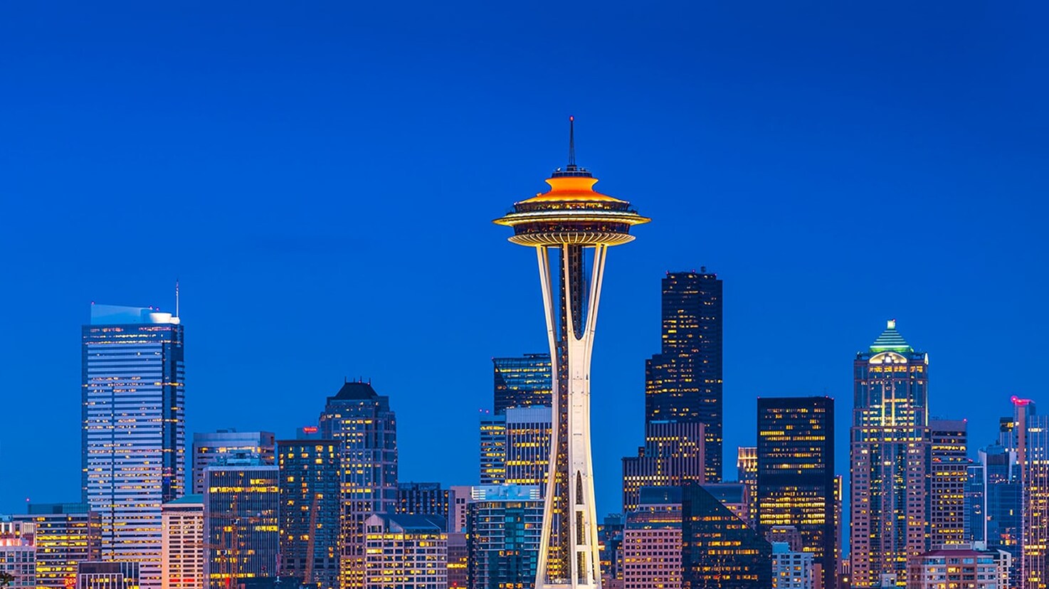 The Seattle skyline at night, featuring the Space Needle, highlighting the waterproofing and resurfacing project profile.