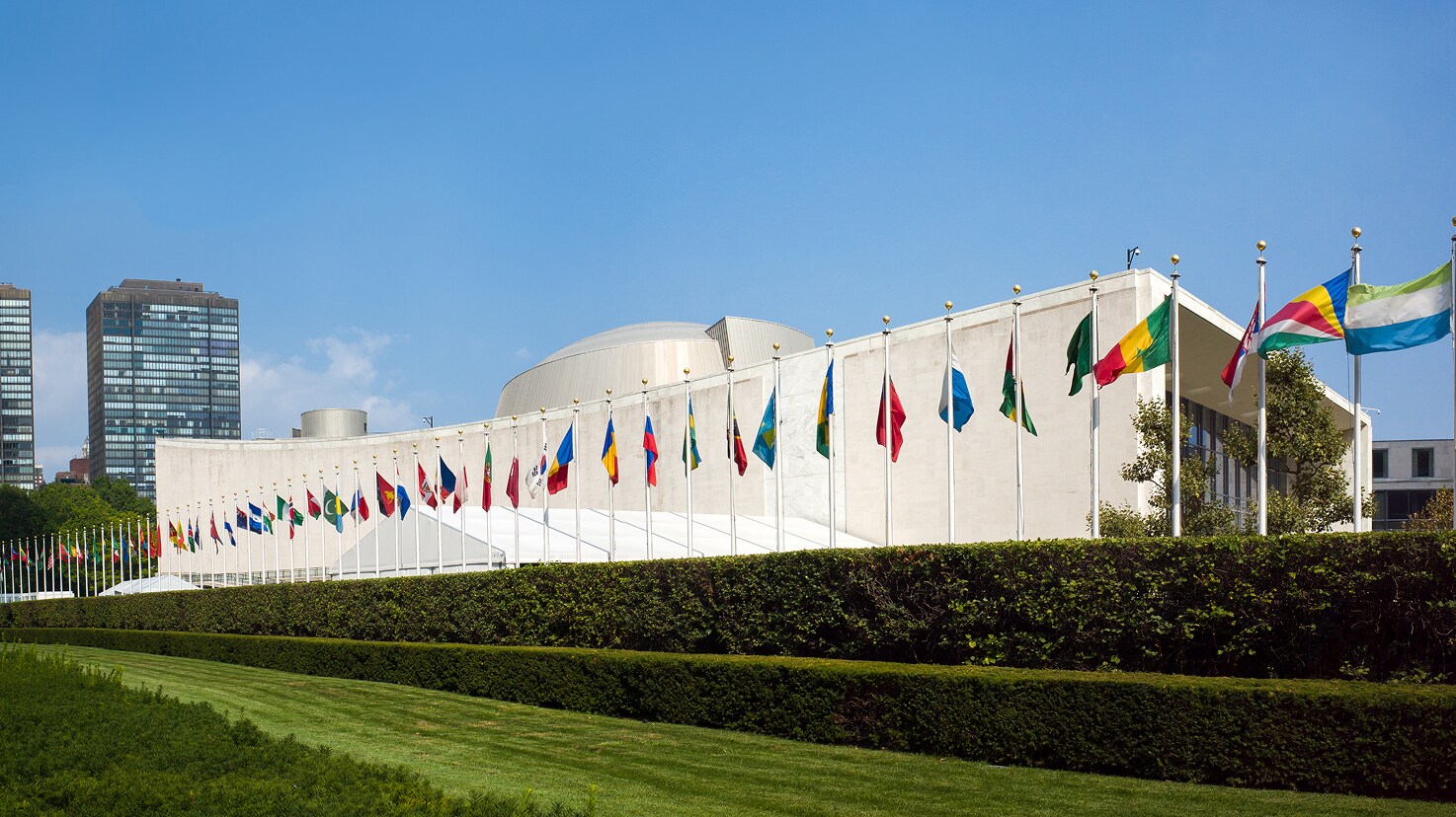 Exterior of the United Nations General Assembly Building with flags, showcasing a Siplast reroofing project profile.