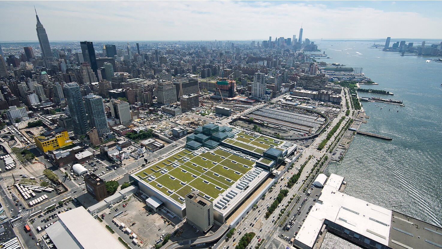 Overhead panorama of a major city showing skyscrapers and a large-scale green roof installation